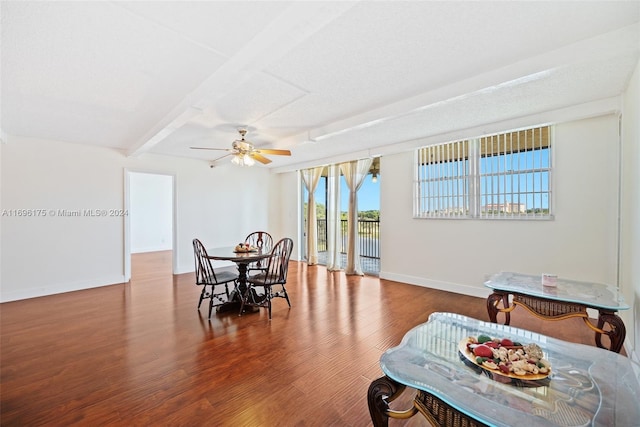 dining room featuring wood-type flooring, a textured ceiling, ceiling fan, and beam ceiling