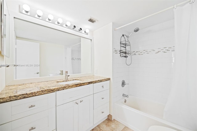 bathroom featuring tile patterned floors, vanity, and shower / bath combo