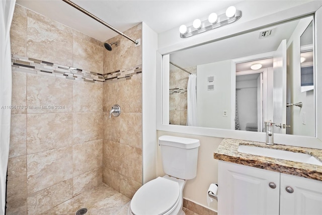 bathroom with toilet, vanity, and walk in shower