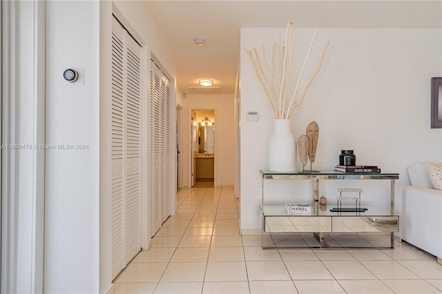 hall featuring light tile patterned floors