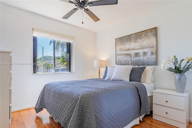 bedroom with ceiling fan and light wood-type flooring