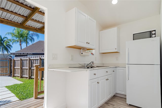 kitchen featuring light hardwood / wood-style floors, white cabinets, wooden ceiling, and white refrigerator