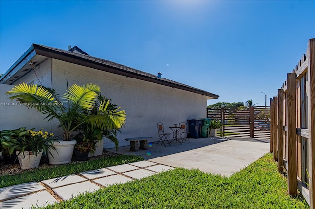 view of side of property featuring a patio area