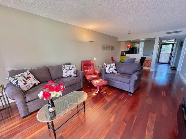 living room with hardwood / wood-style floors and a textured ceiling