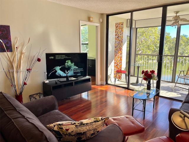 living room featuring expansive windows, a textured ceiling, hardwood / wood-style flooring, and ceiling fan