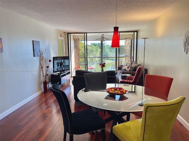 dining area with dark hardwood / wood-style floors, expansive windows, and a textured ceiling