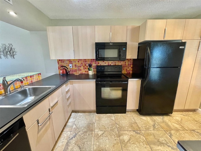 kitchen with black appliances, decorative backsplash, sink, and a textured ceiling