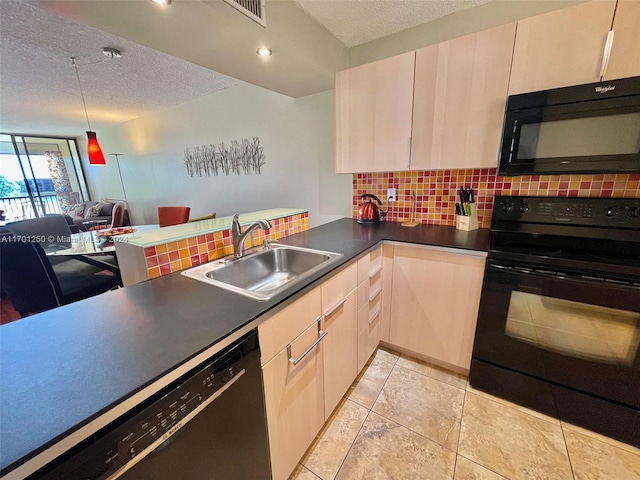 kitchen with black appliances, sink, a textured ceiling, tasteful backsplash, and kitchen peninsula