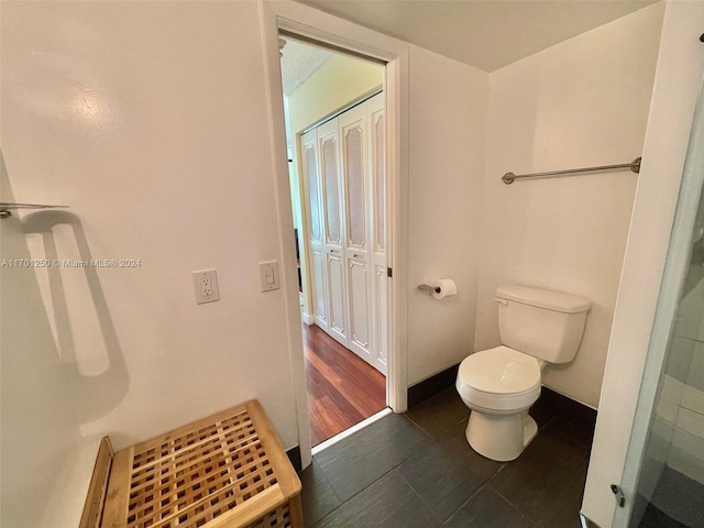 bathroom with hardwood / wood-style floors and toilet