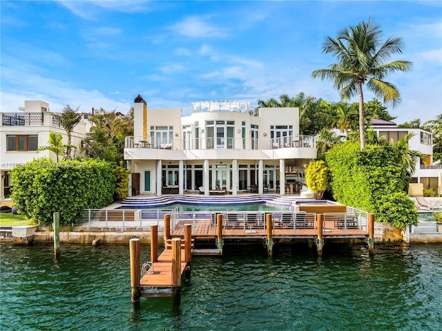 271 N Hibiscus Dr, Miami Beach, FL 33139 - back of house with a balcony, a water view, an outdoor pool, a patio, and a hot tub
