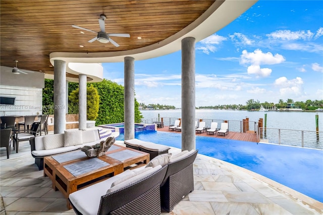 view of patio featuring ceiling fan, a swimming pool with hot tub, a water view, and an outdoor hangout area