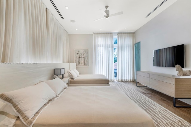 bedroom with hardwood / wood-style floors and ceiling fan