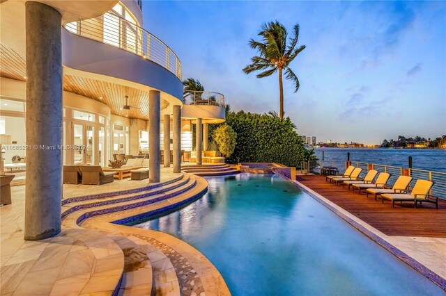 271 N Hibiscus Dr, Miami Beach, FL 33139 - view of pool with outdoor lounge area, a pool with connected hot tub, a water view, and a patio area