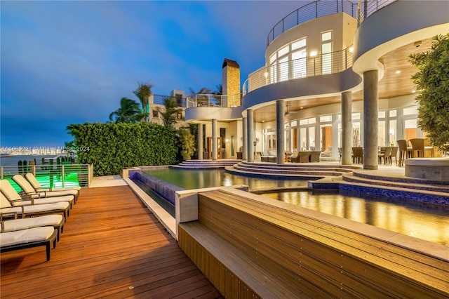 deck at dusk featuring a patio area