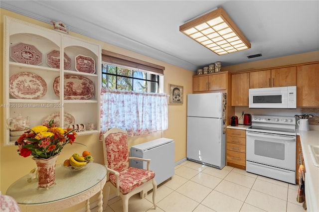 kitchen featuring light tile patterned floors and white appliances