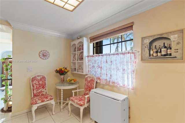 living area featuring light tile patterned floors and crown molding