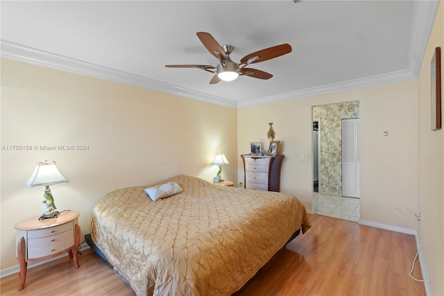 bedroom with hardwood / wood-style flooring, ceiling fan, and crown molding