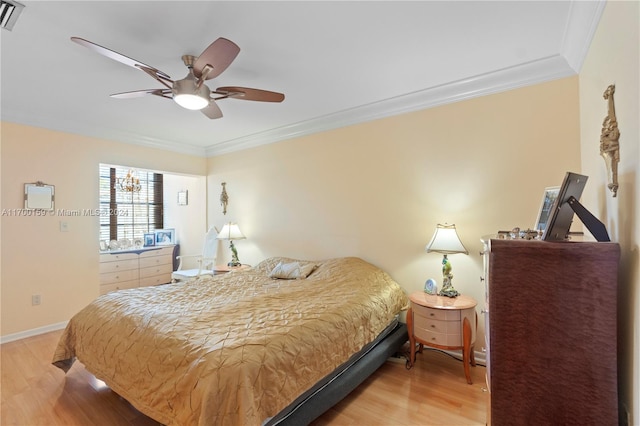 bedroom with hardwood / wood-style flooring, ceiling fan, and ornamental molding