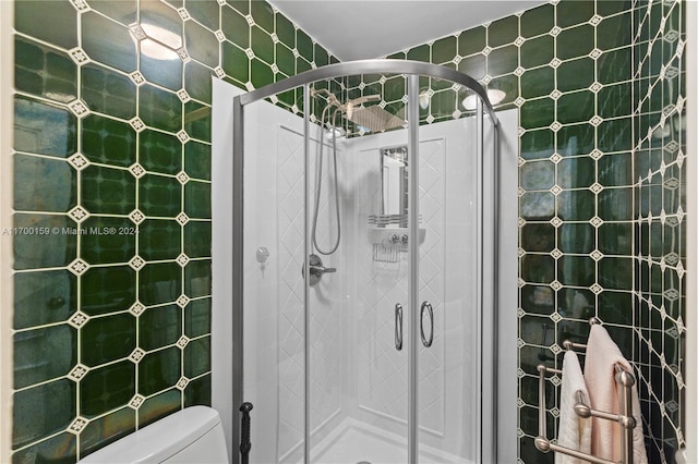 bathroom with toilet and an enclosed shower