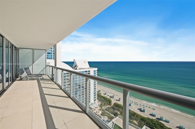 balcony with a beach view and a water view