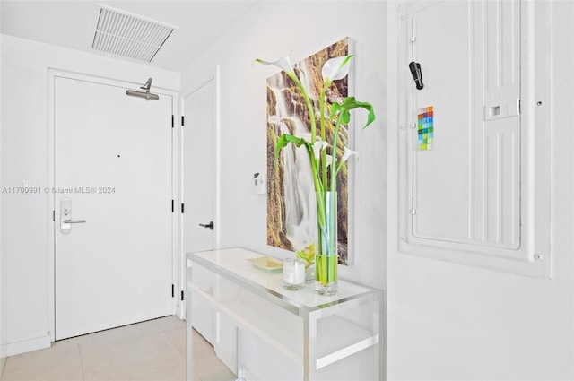 mudroom with light tile patterned floors and electric panel