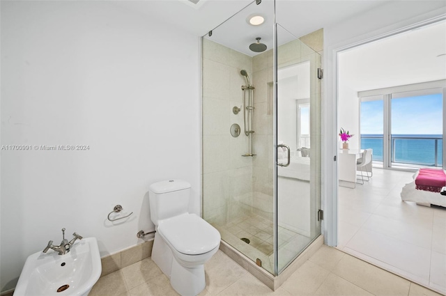 bathroom featuring a shower with door, a water view, a bidet, tile patterned flooring, and toilet