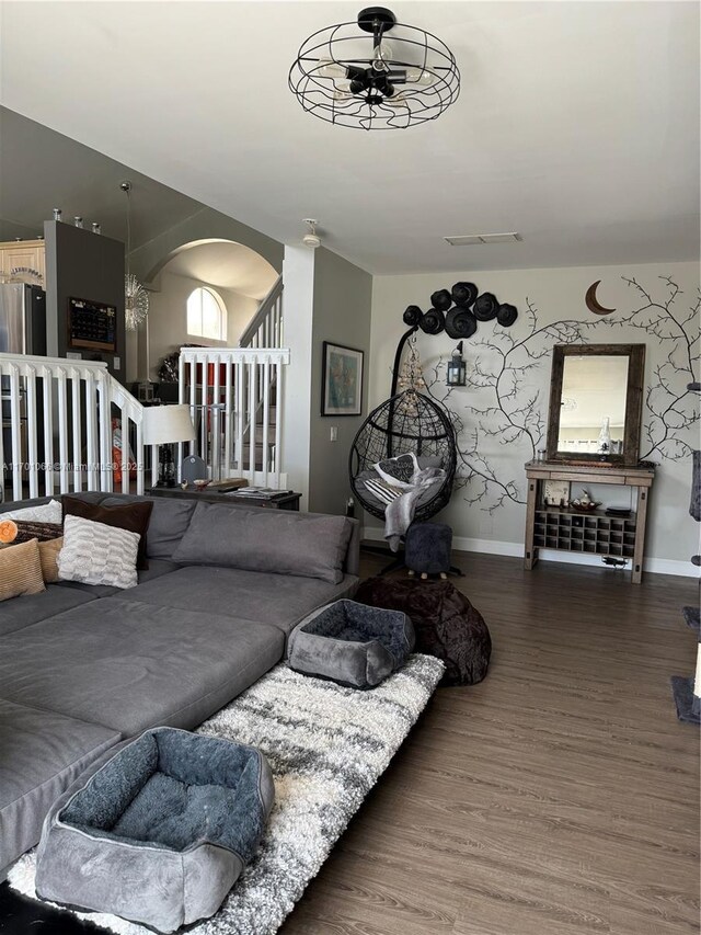 living room with dark hardwood / wood-style floors and ceiling fan