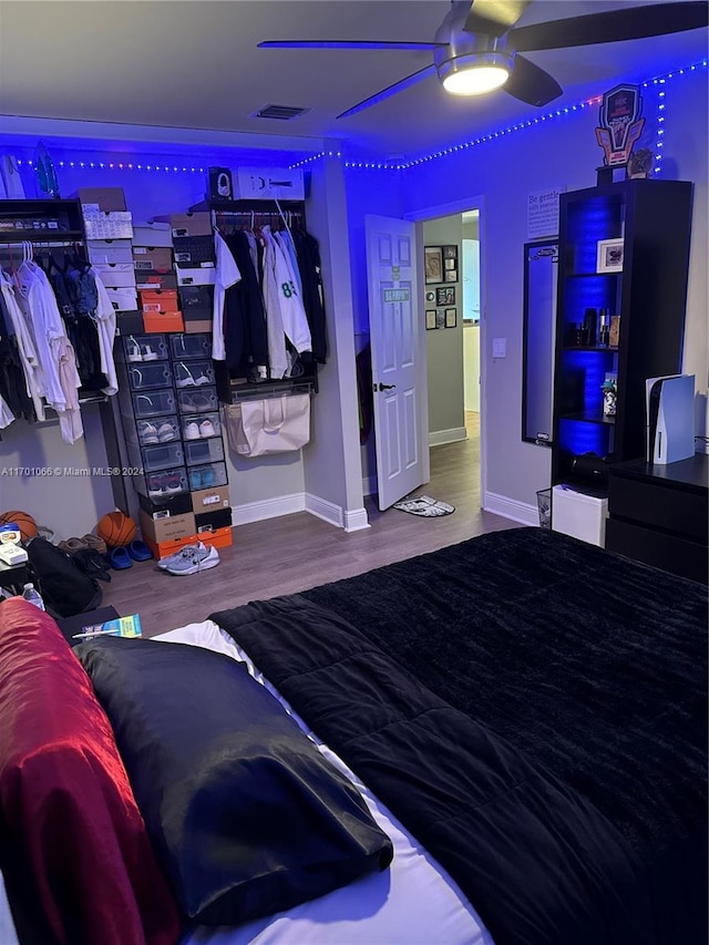 bedroom with ceiling fan and hardwood / wood-style flooring