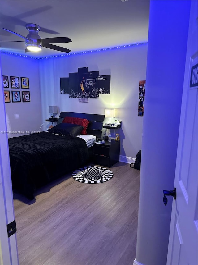 bedroom featuring ceiling fan and hardwood / wood-style floors