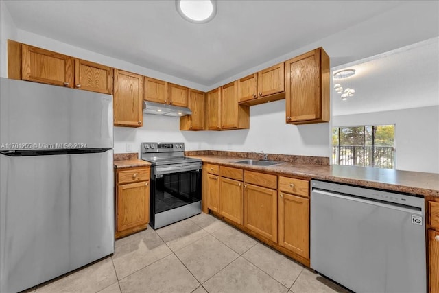 kitchen with light tile patterned floors, sink, and appliances with stainless steel finishes