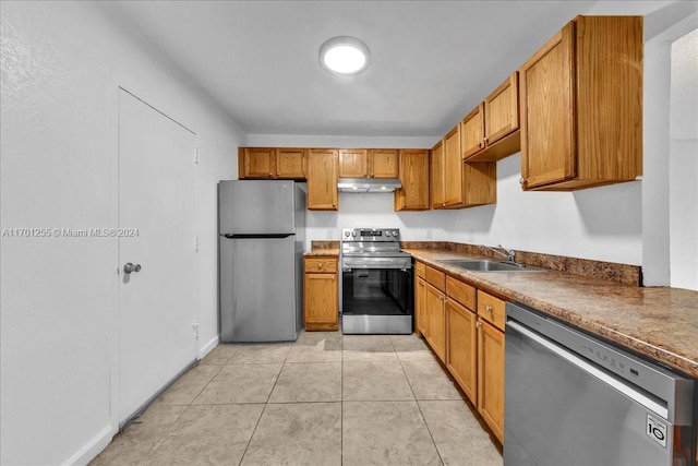 kitchen featuring light tile patterned flooring, sink, and appliances with stainless steel finishes