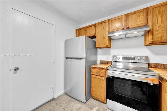 kitchen with light tile patterned floors and stainless steel appliances