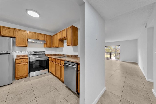 kitchen with sink, light tile patterned floors, and stainless steel appliances