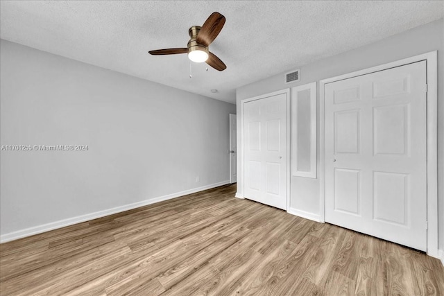 unfurnished bedroom with ceiling fan, light hardwood / wood-style flooring, and a textured ceiling