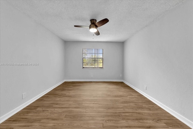 unfurnished room with ceiling fan, wood-type flooring, and a textured ceiling