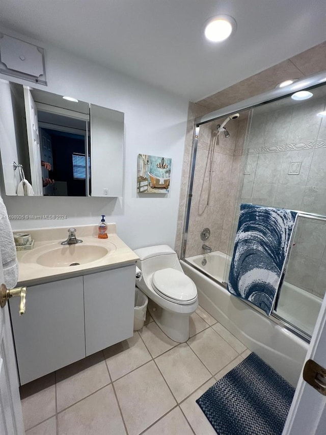 full bathroom featuring tile patterned floors, vanity, toilet, and combined bath / shower with glass door