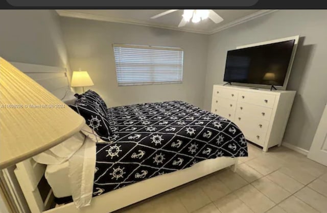 bedroom featuring ceiling fan, light tile patterned floors, and crown molding