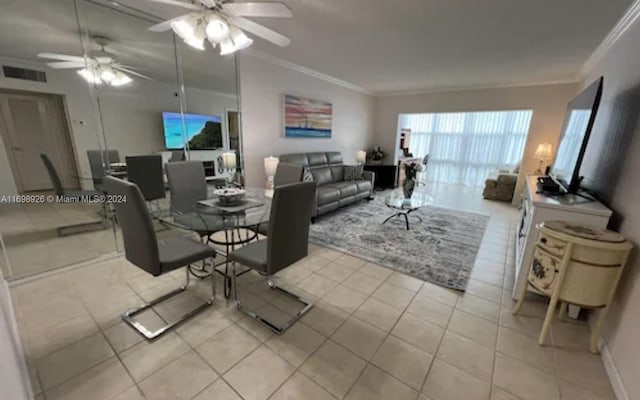 dining area featuring ceiling fan, ornamental molding, and light tile patterned flooring