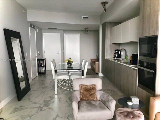 2900 NE 7th Ave Unit 3608, Miami, FL 33137 - kitchen featuring black appliances, modern cabinets, light marble finish floors, white cabinetry, and light countertops