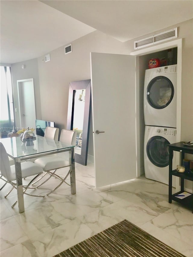 2900 NE 7th Ave Unit 3608, Miami, FL 33137 - washroom featuring stacked washer and clothes dryer and light marble finish floors