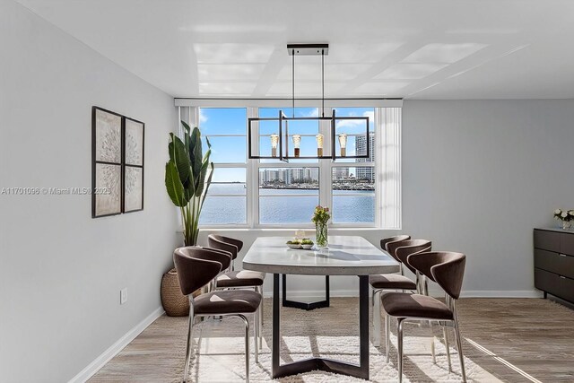 kitchen featuring light wood-type flooring, backsplash, stainless steel appliances, sink, and white cabinets