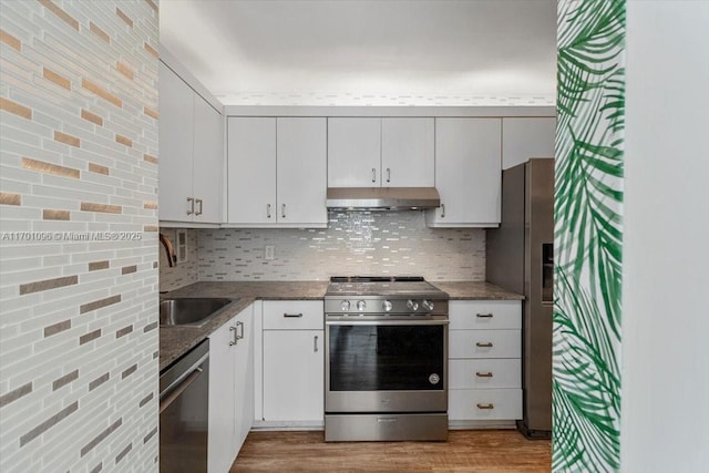 kitchen featuring tasteful backsplash, sink, white cabinetry, and stainless steel appliances