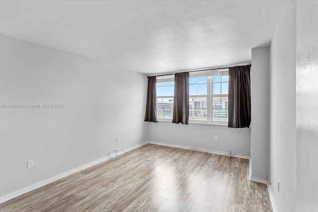 spare room with light hardwood / wood-style flooring