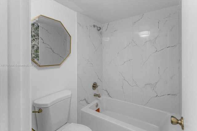 bathroom featuring tiled shower / bath combo and toilet