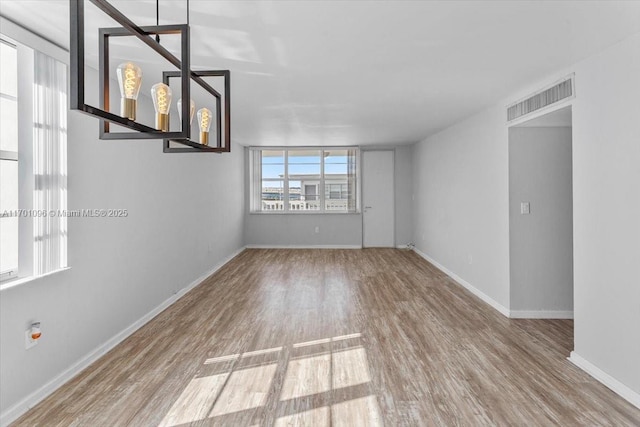 unfurnished room featuring hardwood / wood-style flooring