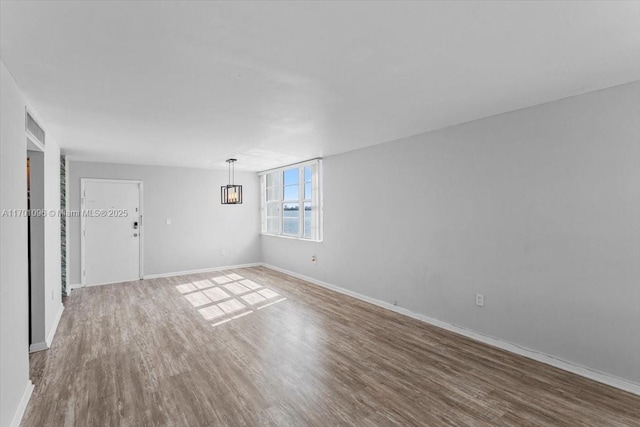 empty room with hardwood / wood-style floors