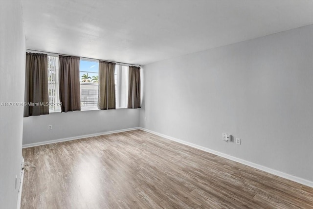 unfurnished room featuring hardwood / wood-style flooring