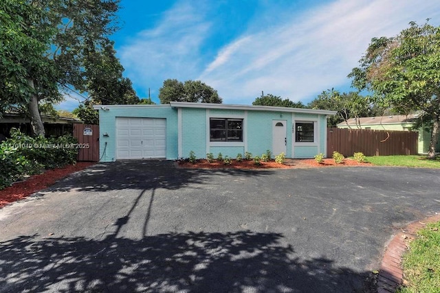 ranch-style home featuring a garage