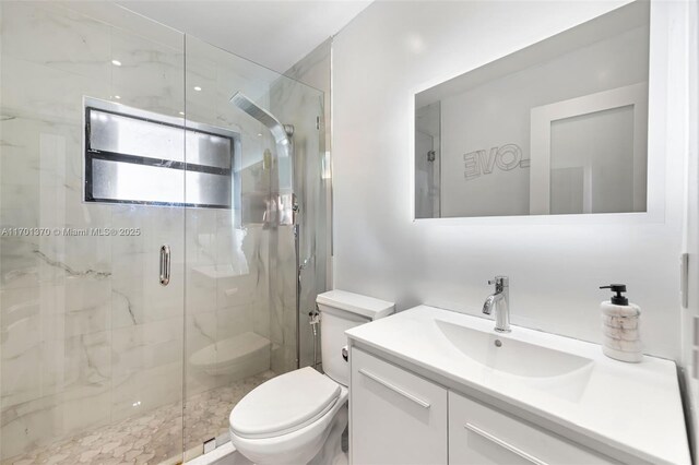 bathroom with an enclosed shower, vanity, and toilet