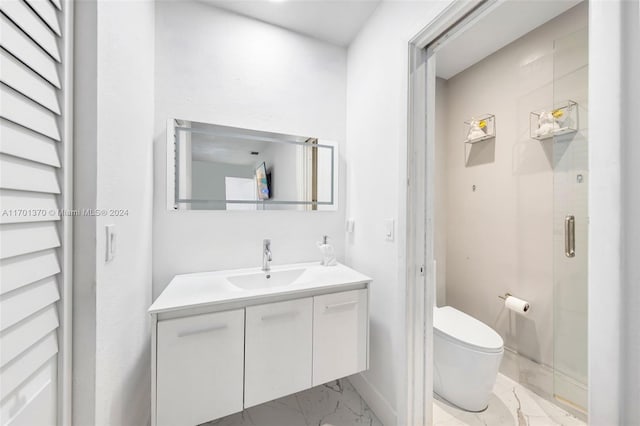 bathroom with vanity, an enclosed shower, and toilet